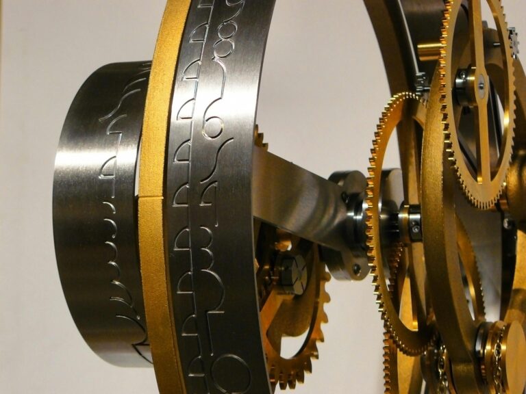 About Close-up of a complex gear mechanism showcasing intricate metal patterns and craftsmanship.